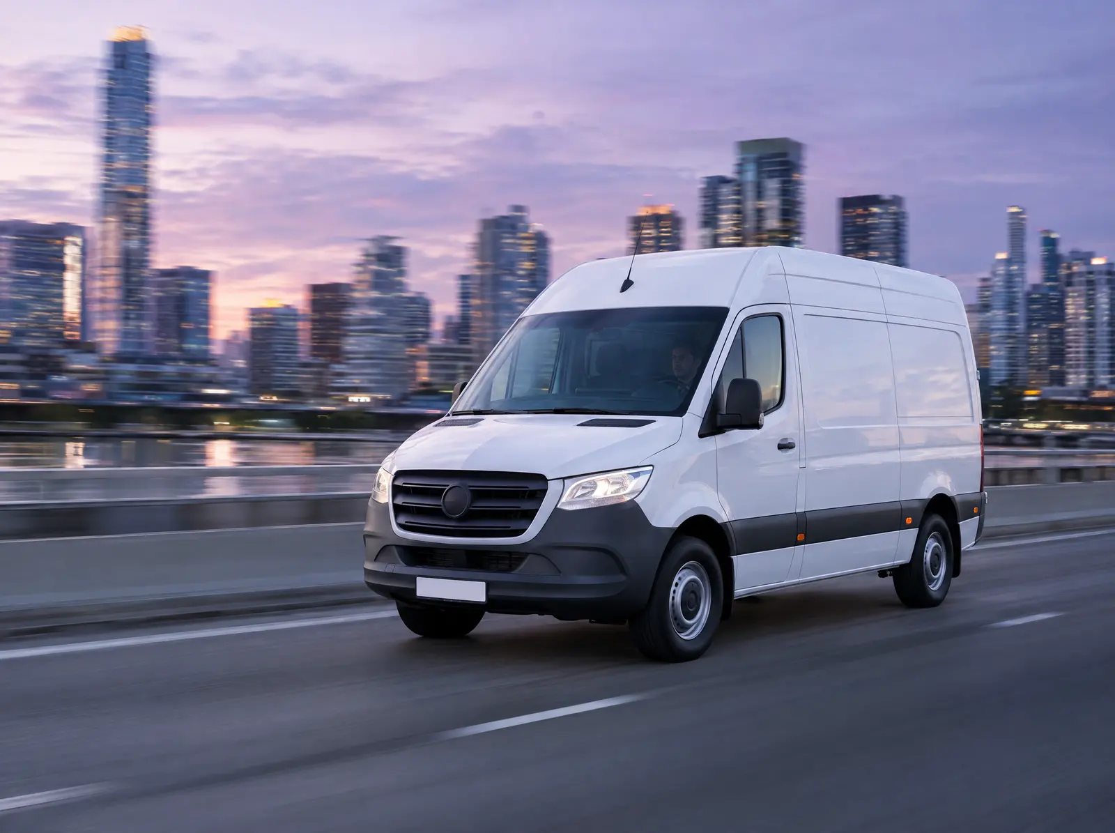 A white cargo van driving at speed on a city highway
